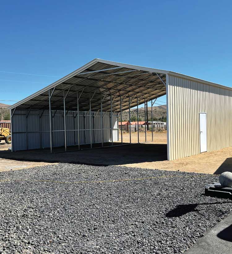 Durable 40x60x16 commercial metal buildings structure featuring a wide overhead door and custom side entrance for business use.